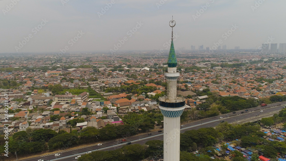 Fototapeta premium aerial view minaret mosque Al Akbar against city Surabaya highway, skyscrapers, buildings and houses. mosque in Indonesia Al Akbar in Surabaya, Indonesia. beautiful mosque with minarets on island Java