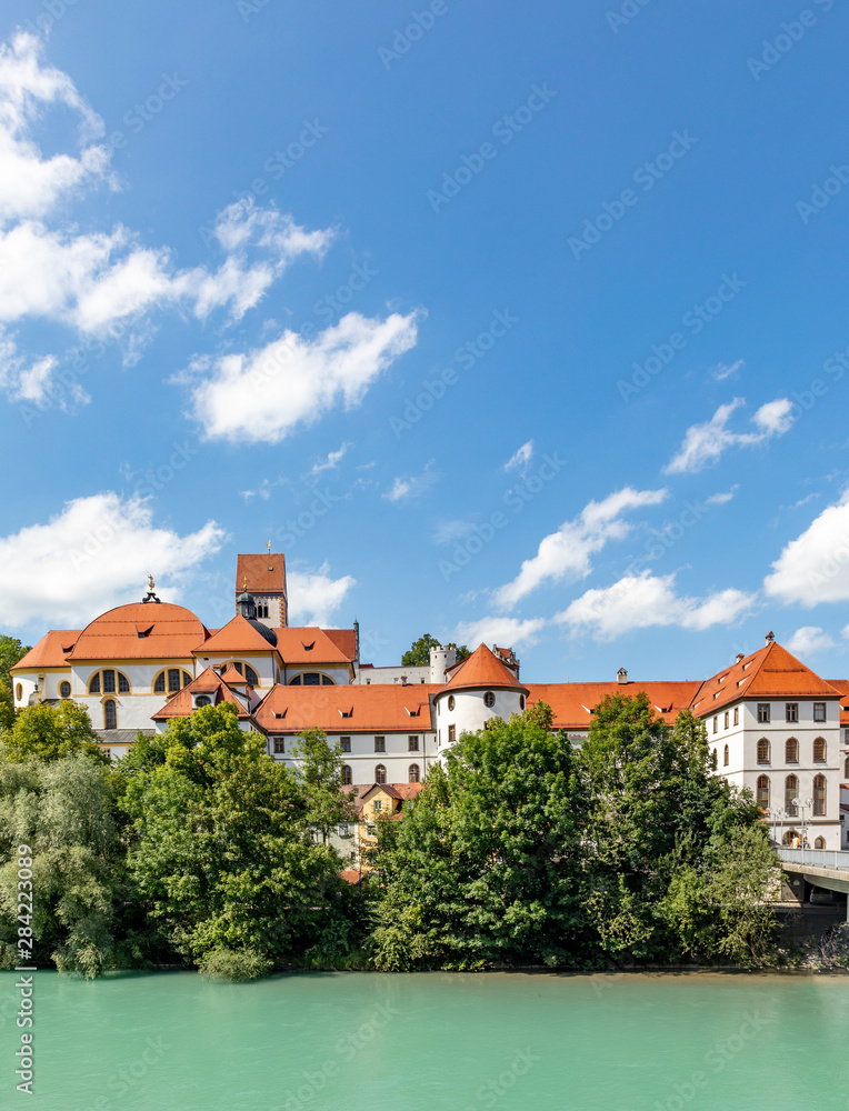 High Palace and Saint Mang monastery in Fuessen on river Lech, Germany