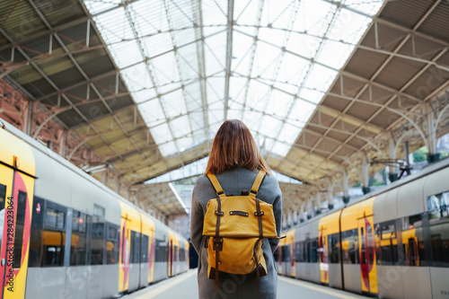 Beautiful portuguese woman traveler waiting at train station. Travel and vacation concept. Urban lifestyle.
