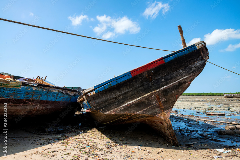 Close up wooden fishing boats on shore in Zanzibar Close up wooden fishing boats on shore in Zanzibar