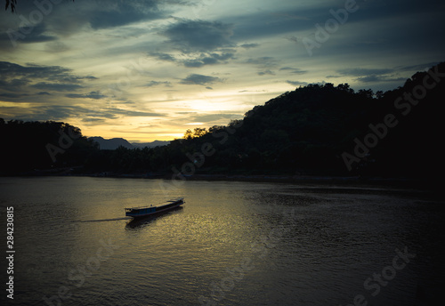 sunset on the river with a boat in southeast of Asia 