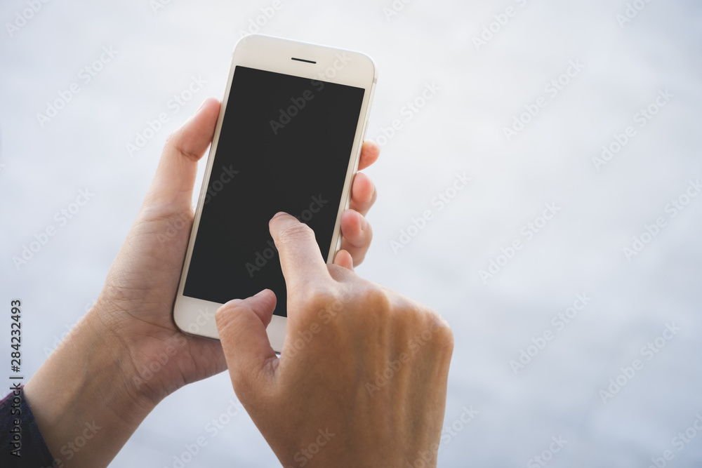 Woman using smart phone with blank screen