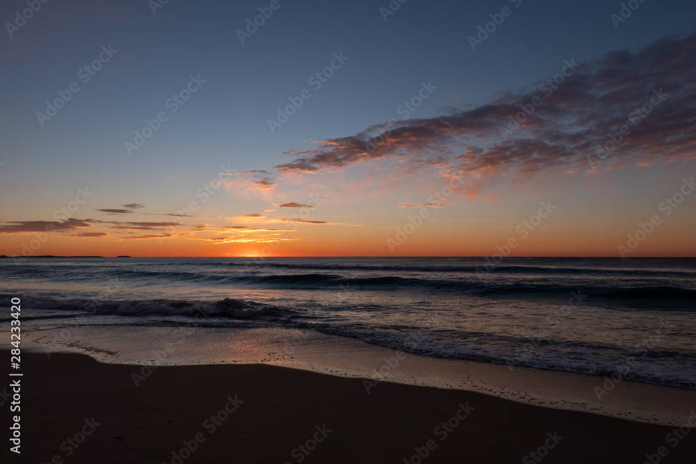 Stunning, golden sunrise over Windang Beach, NSW, Australia