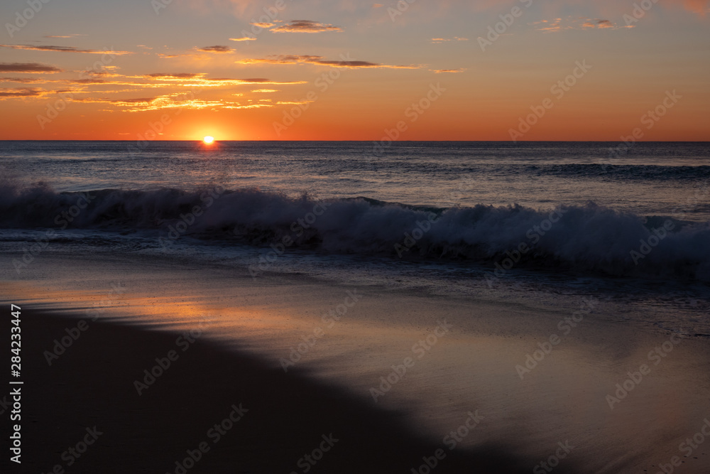 Stunning, golden sunrise over Windang Beach, NSW, Australia