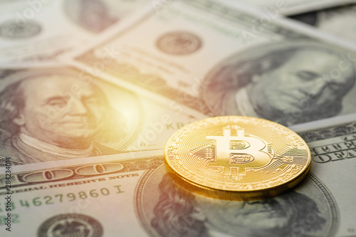 bitcoin golden coin on US dollar banknote background photo