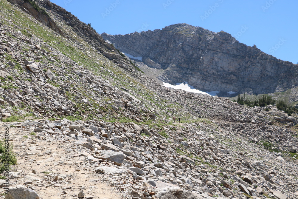 Hiker reaching White Pine lake mountain pass in Wasatch Mountains Hiker reaching White Pine lake mountain pass in Wasatch Mountains