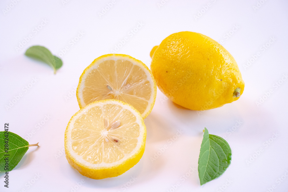 freshCreative layout made of lemon and leaves. Flat lay. Food concept. Lemon on white background freshCreative layout made of lemon and leaves. Flat lay. Food concept. Lemon on white background