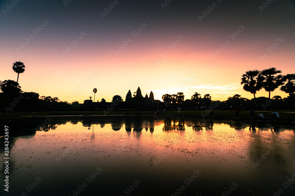 Angkor Wat Temple in Cambodia with sunset (Dawn) skies with the reflection of a religious monument of architecture. Angkor Wat Temple in Cambodia with sunset (Dawn) skies with the reflection of a religious monument of architecture.