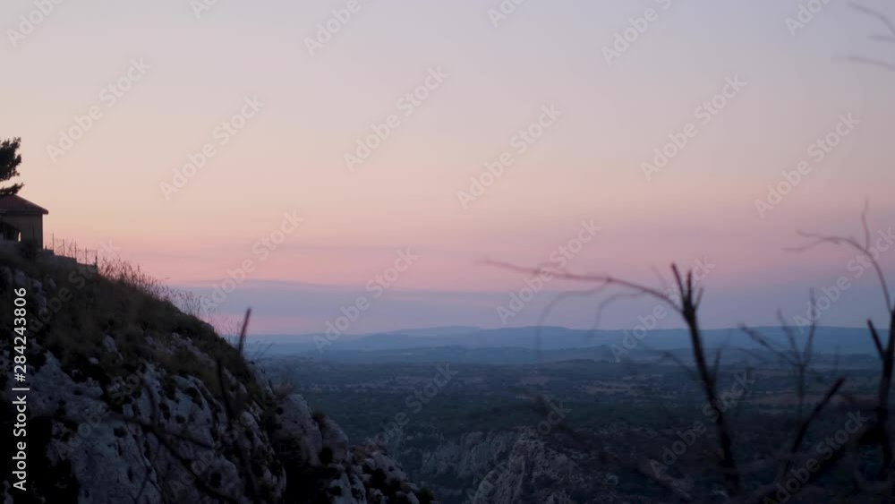 Tracking Wide View of Italian Home on Hill with Colorful Sunset Over Stony Mountain Valley in Italy Tracking Wide View of Italian Home on Hill with Colorful Sunset Over Stony Mountain Valley in Italy