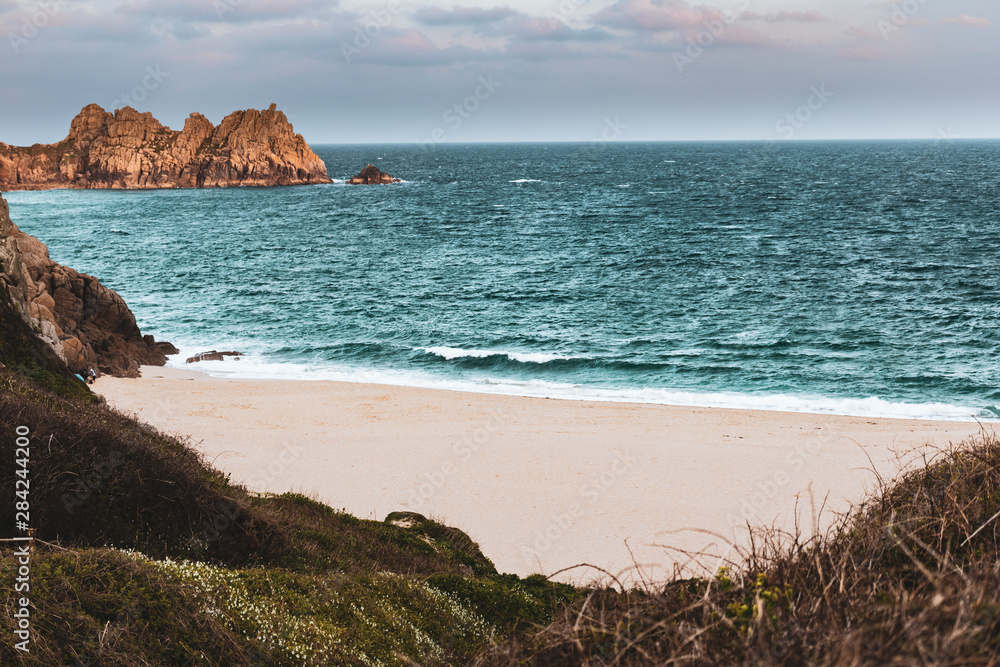 Seaside beach coastal with water and waves in Cornwall, England.