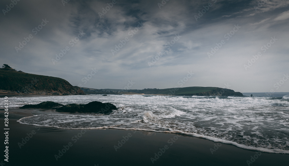 Bigbury Beach with White Waves during high winds in Devon, England.