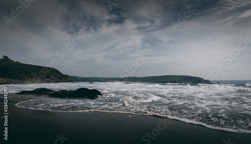 Bigbury Beach with White Waves during high winds in Devon, England.