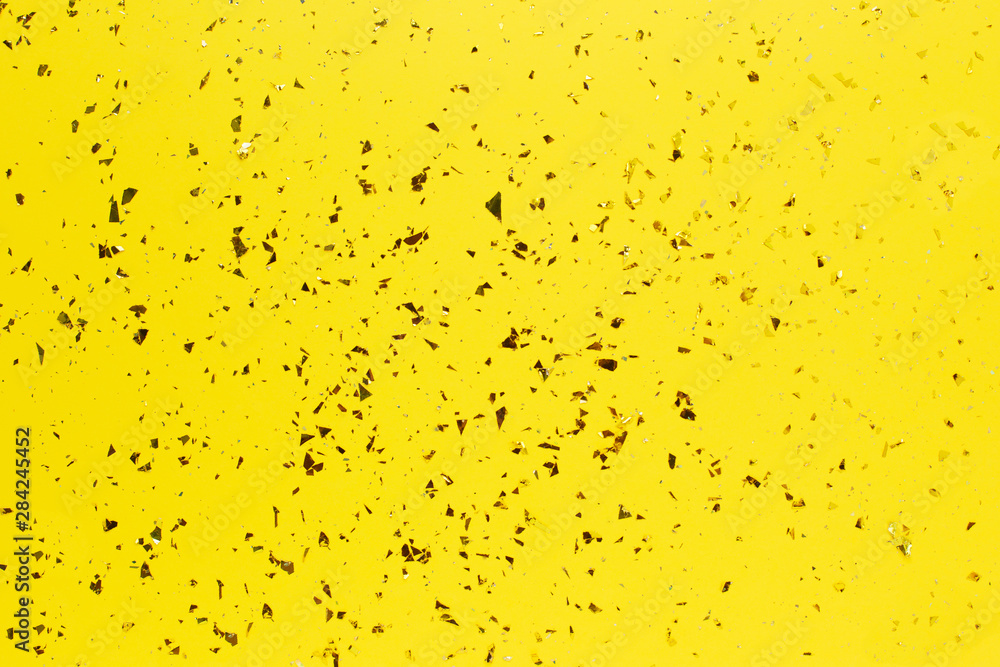 Golden sparkles on bright yellow trendy background. Golden sparkles on bright yellow trendy background.