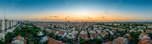 Sunset over Rishon Lezion, Bat Yam and the Tel Aviv skyline with typical middle class Israeli single family homes