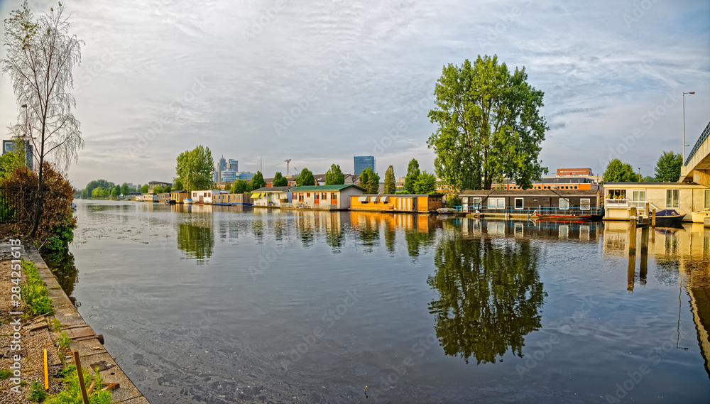 Amsterdam floating houses in river Amstel channel