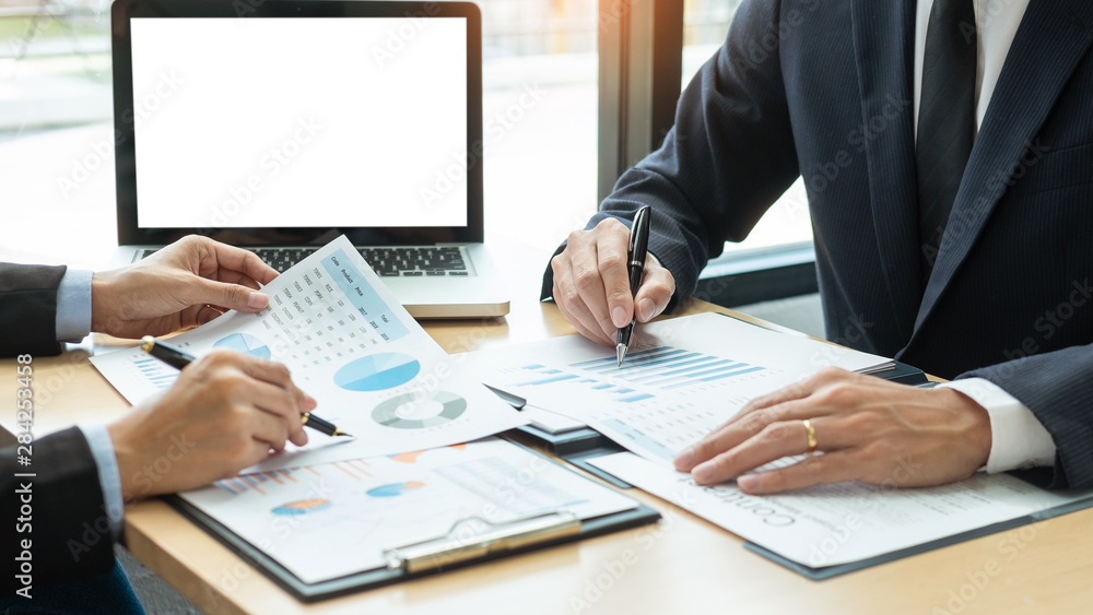 Business People Talking Discussing with coworker planning analyzing financial document data charts and graphs in Meeting and successful teamwork Concept. Business People Talking Discussing with coworker planning analyzing financial document data charts and graphs in Meeting and successful teamwork Concept.