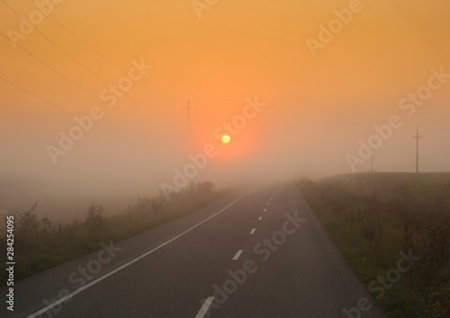 sunset light in fog. road trip, transportation concept