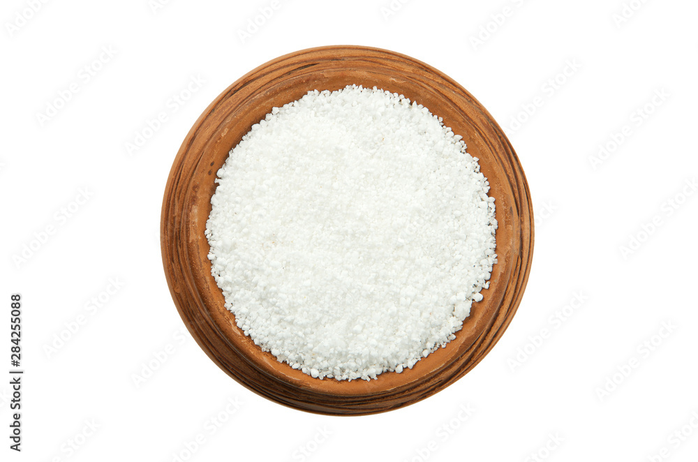 Citric acid in a glossy cup isolated on a white background. View from above. Citric acid in a glossy cup isolated on a white background. View from above.