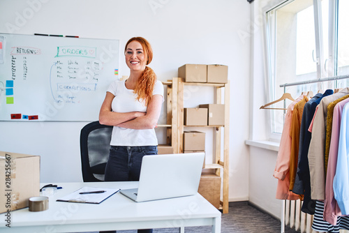 Portrait of young businesswoman standing proudly in office and storage space