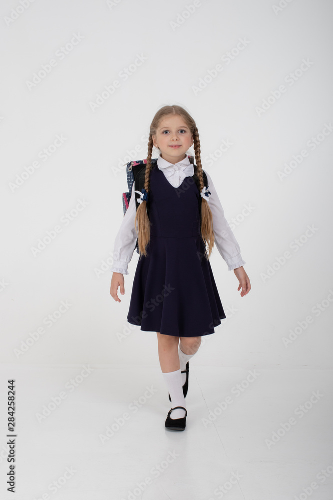 little schoolgirl in school uniform on a white background little schoolgirl in school uniform on a white background