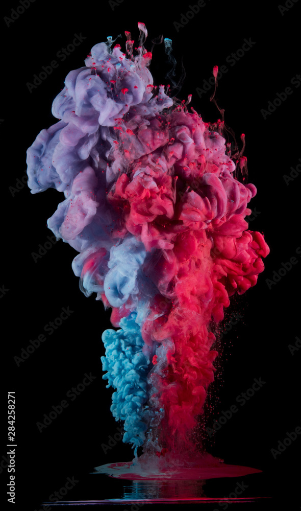 Paint drops from above mixing in water. Ink swirling underwater. Pink, purple, blue colors Paint drops from above mixing in water. Ink swirling underwater. Pink, purple, blue colors