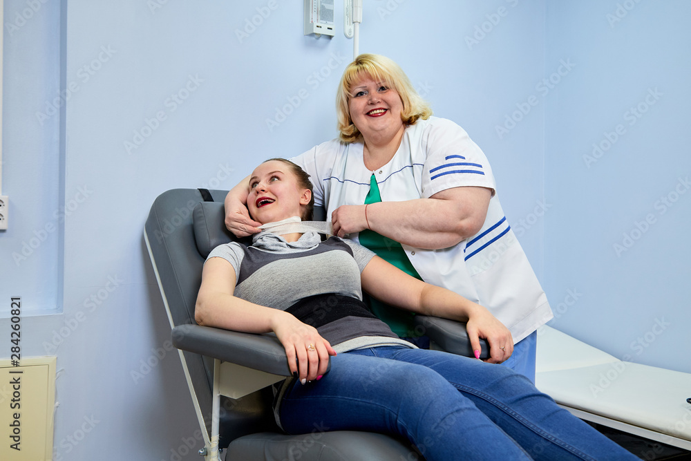 Obraz premium Experienced doctor fat woman taking care of a sick girl on the couch in the medical office