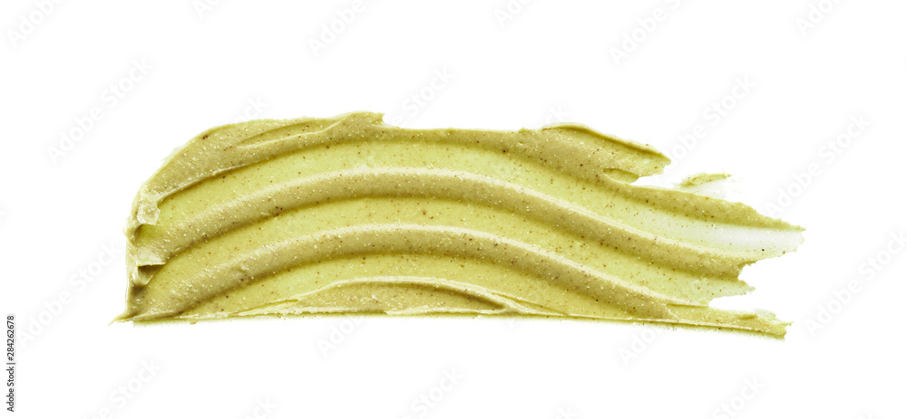 Texture and strokes of a light green organic mask for face or body cream isolated on white background Texture and strokes of a light green organic mask for face or body cream isolated on white background