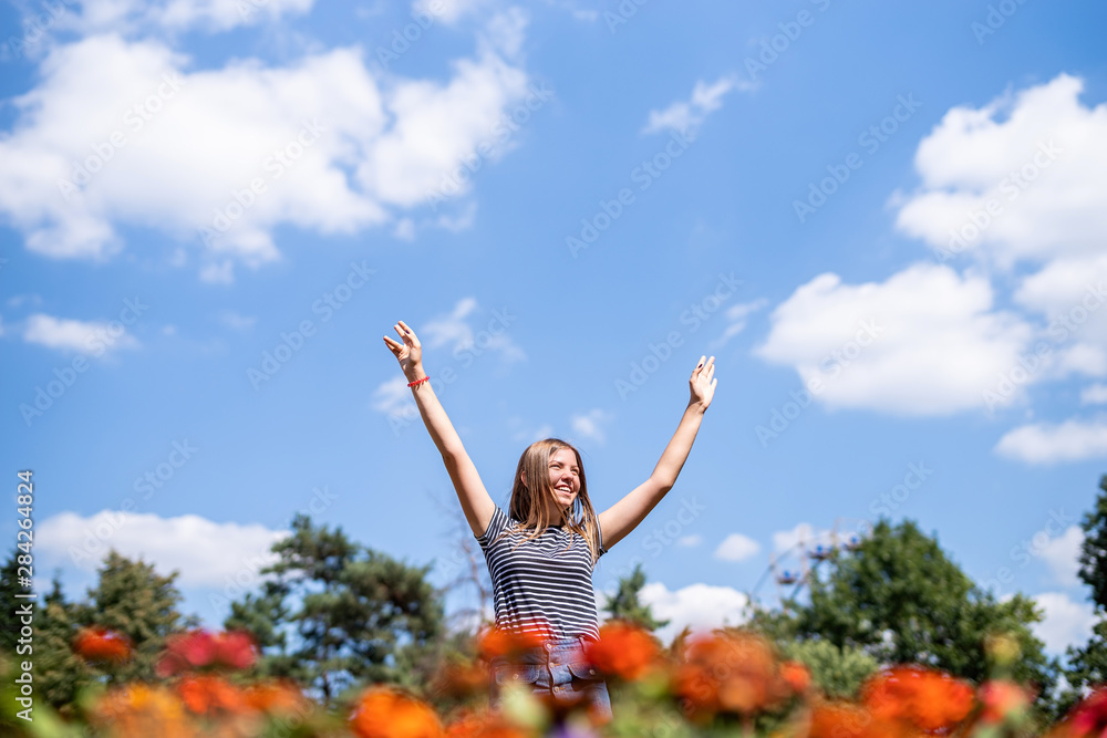 Happy laughing woman in a sunny day in nature in summer with open hands Happy laughing woman in a sunny day in nature in summer with open hands
