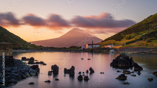 Colourful Sunrise in Horta, Faial Island: long Exposure of the Porto Pim Beach, the Whaling Station and the Pico Volcano Mountain in the background, Azores Islands, Portugal. photo