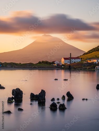Colourful Sunrise in Horta, Faial Island: long Exposure of the Porto Pim Beach, the Whaling Station and the Pico Volcano Mountain in the background, Azores Islands, Portugal.