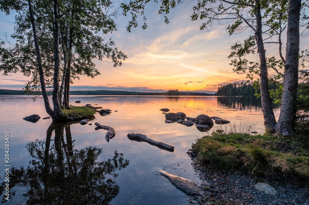 Idyllic landscape with beautiful sunset and tranquil mood at summer evening in Loppi, Finland