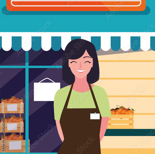 saleswoman with fresh fruits store facade building