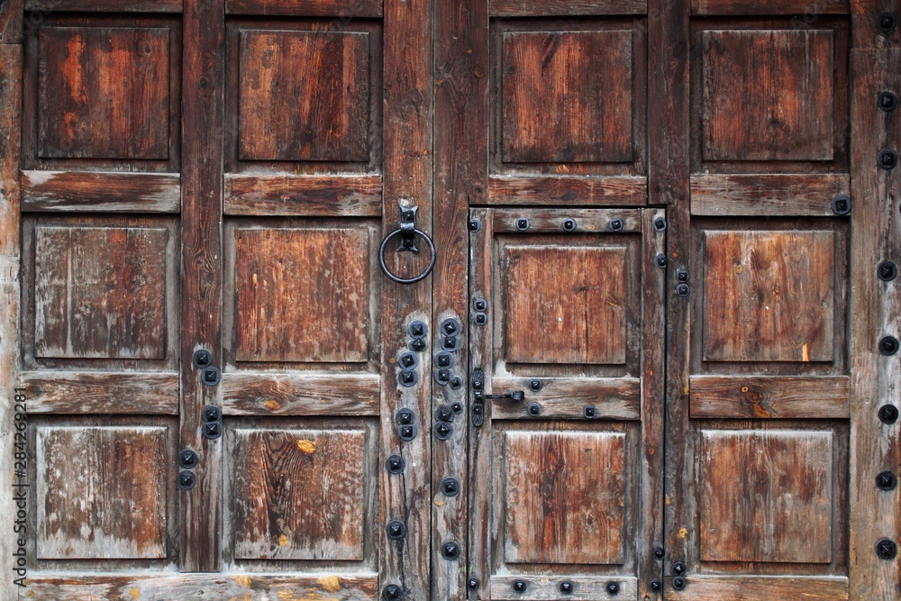 Rustic wooden gate fixed with brass rivets Rustic wooden gate fixed with brass rivets