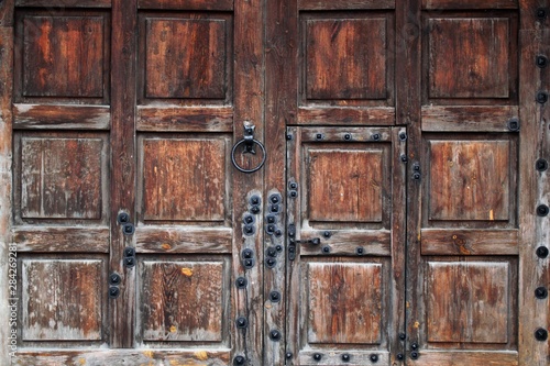 Rustic wooden gate fixed with brass rivets © Ivanna