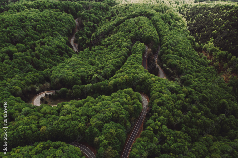 Windy forest mountain road in the spring seen from above Windy forest mountain road in the spring seen from above