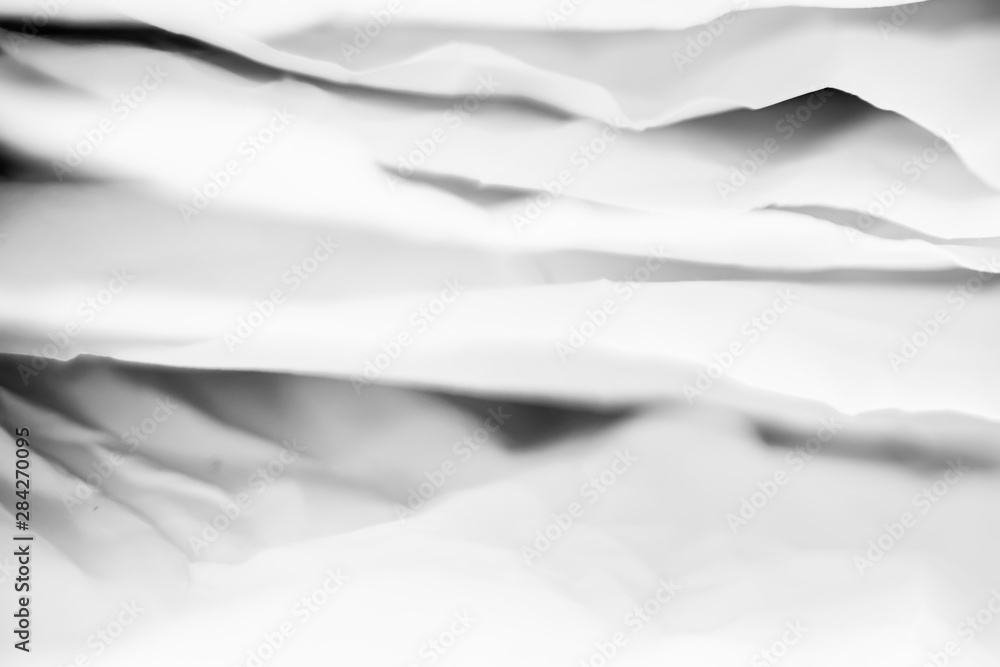 Obraz premium White crumpled paper layers with black shades. Creative design. Abstract background. Copy space.