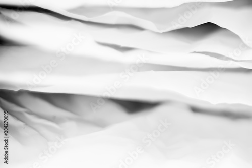 Fototapeta Naklejka Na Ścianę i Meble -  White crumpled paper layers with black shades. Creative design. Abstract background. Copy space.
