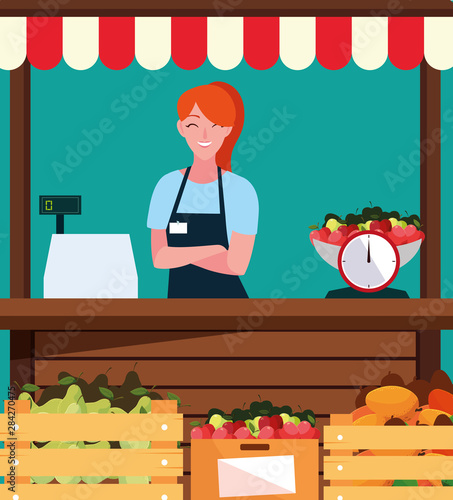 saleswoman with stall kiosk facade of store fruits