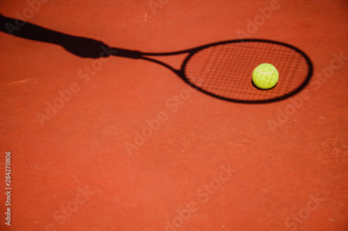 shadow tennis player with a ball on the court © Sergey