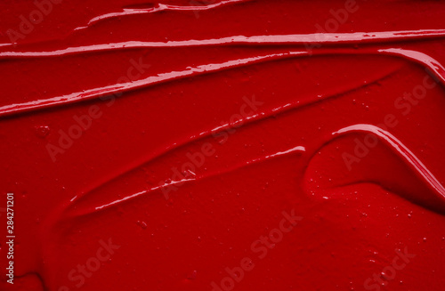 Smear and texture of red lipstick or acrylic paint isolated on white background. photo