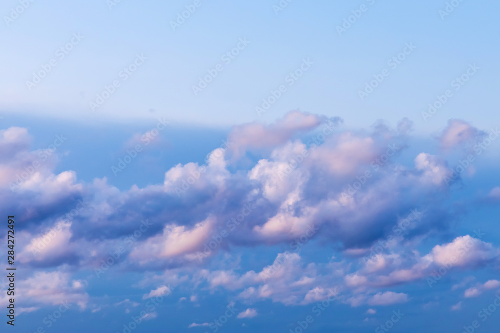 The vivid sky or heaven background with white and blue clouds under the sun rays The vivid sky or heaven background with white and blue clouds under the sun rays