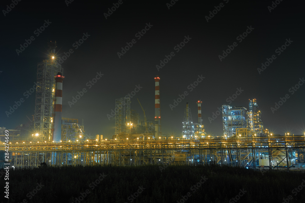 the form of metal pipes of a refinery in the open air at night the form of metal pipes of a refinery in the open air at night