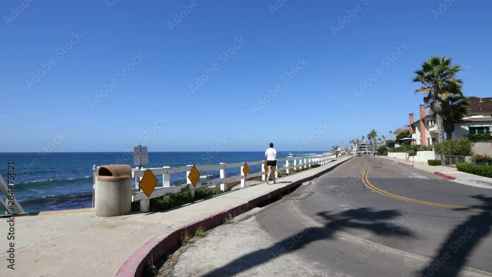 Woman running by the ocean cliff in California in 4K Woman running by the ocean cliff in California in 4K