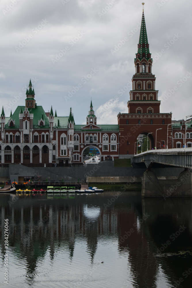 Beautiful buildings on the embankment in Yoshkar-Ola, reflected in the river