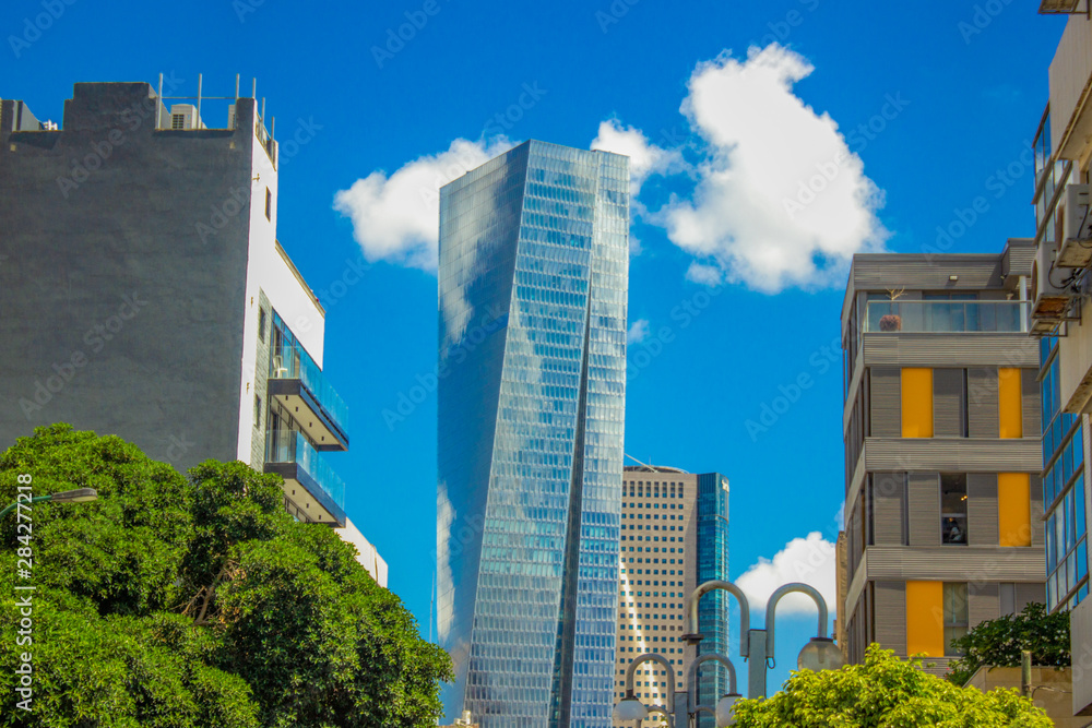 fuzzy urban vivid colorful photography of Tel Aviv glass skyscraper and ordinary living building landmark city view in bright clear summer weather time 