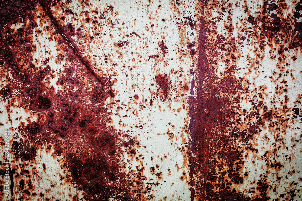 Old metal rusted wall partly covered with peeling paint. Grunge texture and background. Close-up Old metal rusted wall partly covered with peeling paint. Grunge texture and background. Close-up