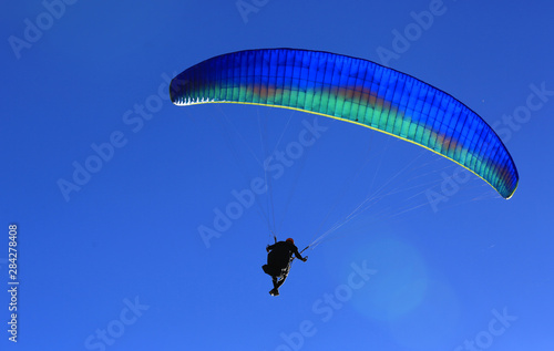 paraglider in blue sky
