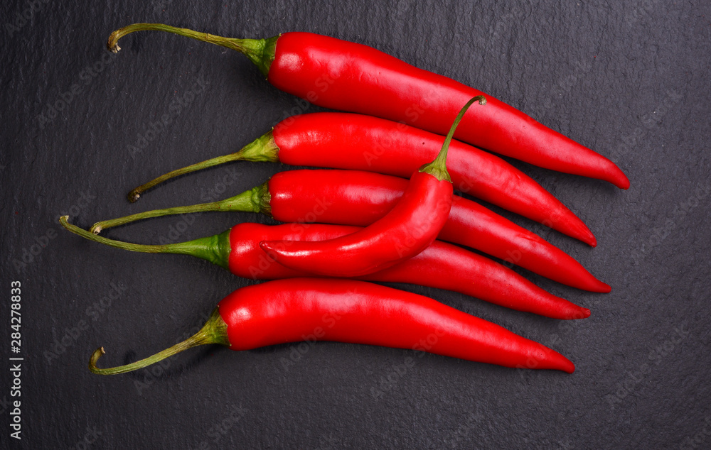 Fresh Chili pepper on dark background. View from above