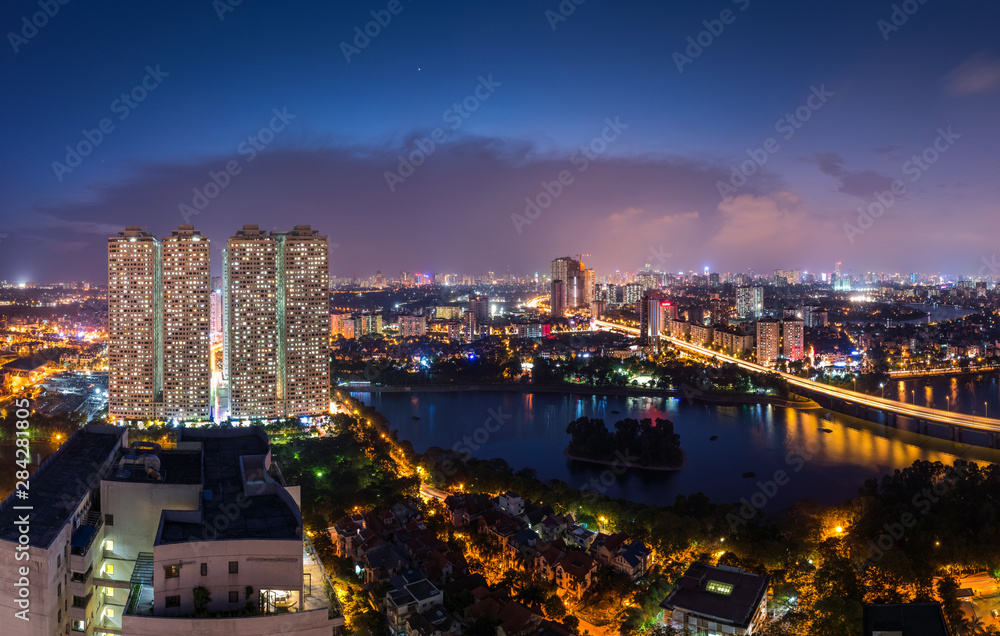 Aerial skyline view of Hanoi at Linh Dam lake, Belt Road No. 3. Hanoi cityscape by sunset period