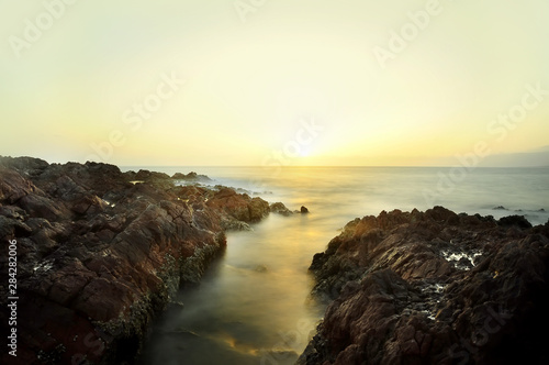 Dawn on the wild coast of the island in the Indian Ocean. long exposure.